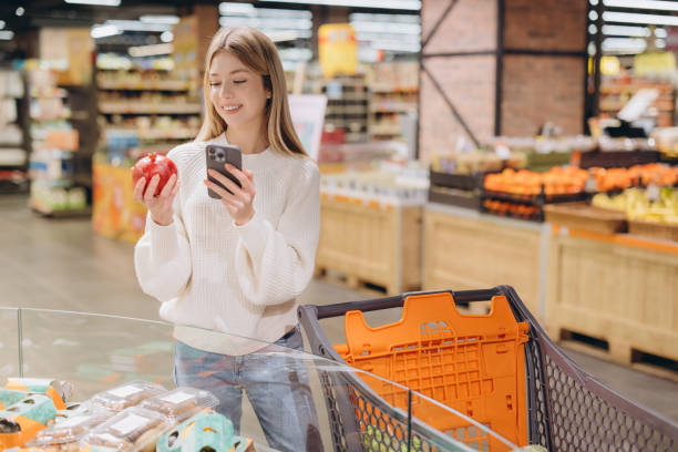 istock Customer using smartphone and choosing pomegranate in supermarket 2190169466