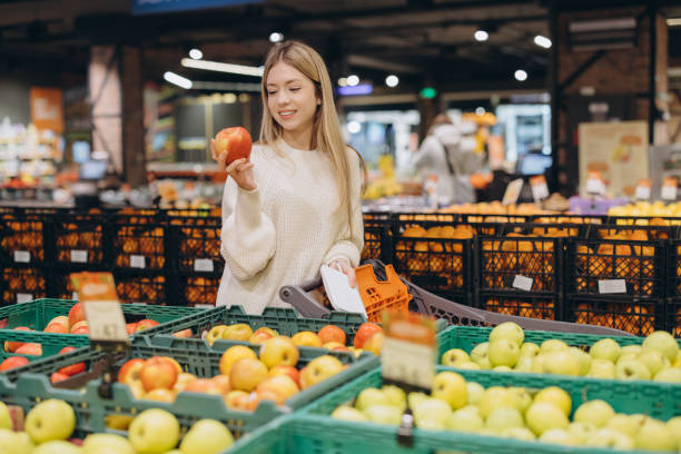 istock Customer choosing red apple in supermarket fruit and vegetable section 2190169657