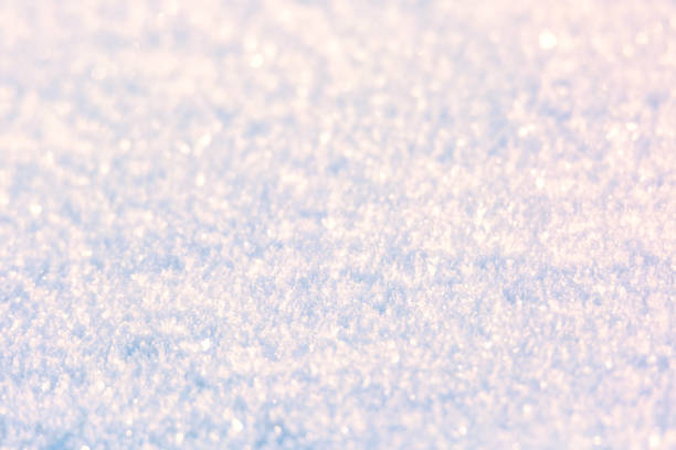 Snow surface texture background. Crystals and snowflakes. Winter natural christmas background. Selective focus.