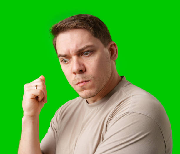 istock Thoughtful man gestures against a green background 2190170882