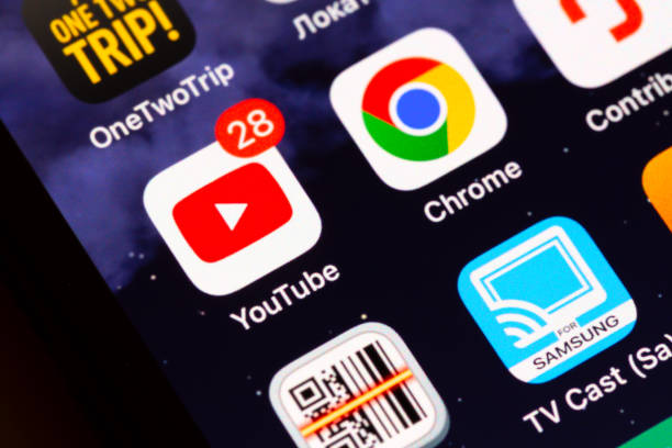 Moscow, Russia - December 13, 2024: YouTube and Google Chrome app icons on display of an iPhone.