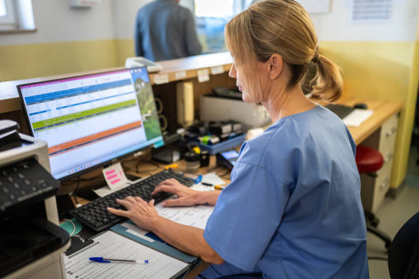 istock Hospital receptionist working at reception desk 2190173576