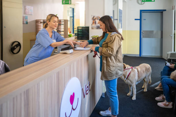 istock Mature Women Doing Paperwork at Veterinary Clinic Reception 2190173649