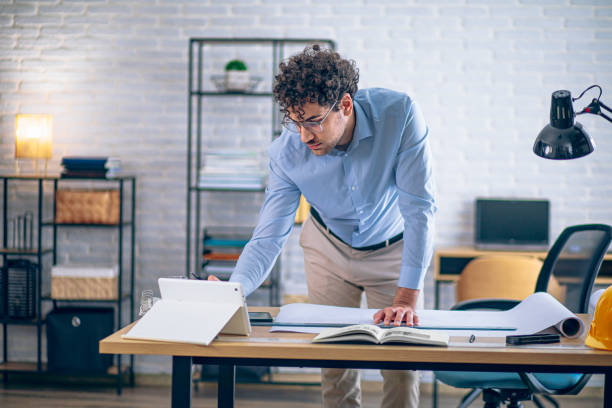 istock Engineer man working in the office, drawing and planning the construction project. 2190174257