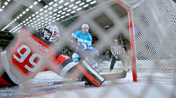 istock Behind the Net: Ice Hockey Goalie Blocks Shot 2190174556