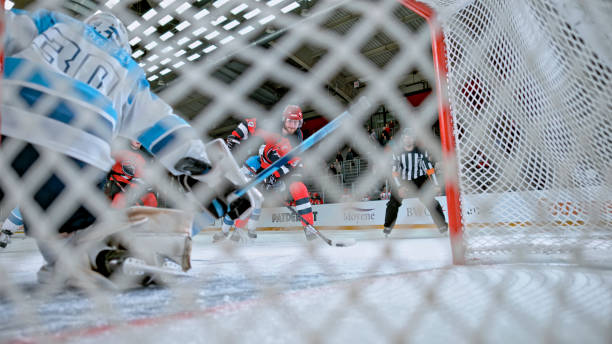 istock Ice Hockey Shot on Goal Viewed Through the Net 2190174585