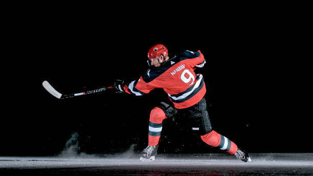 istock Professional Ice Hockey Player: a Powerful One-Timer Against Dark Background 2190174691