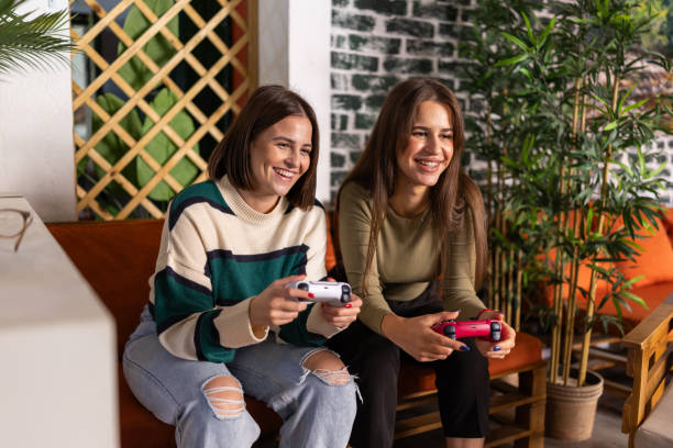 istock Female friends playing video games 2190174775