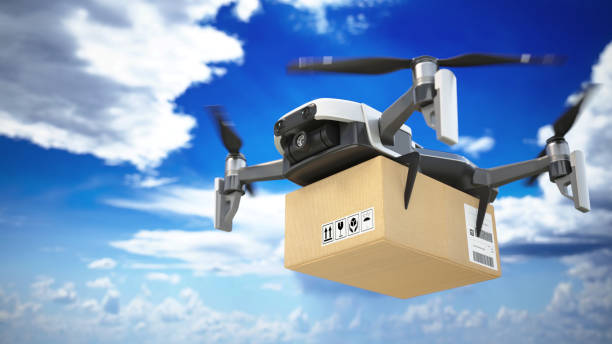 istock Delivery drone transporting package across a clear blue sky during daytime. 2190175469