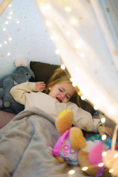 istock A tired girl cries while lying in a tent 2190178294