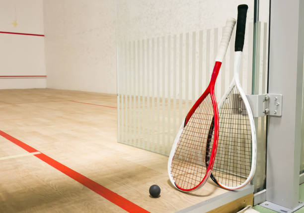 Empty squash court and rackets on the wooden floor. High quality photo