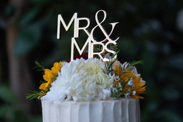 istock Wedding cake with Mr & Mrs topper and flowers. 2190179046