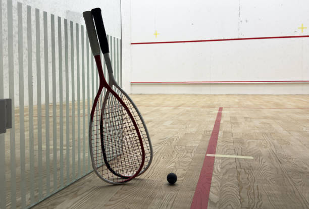 istock Two rackets and two squash balls lie on the parquet floor. 2190179279