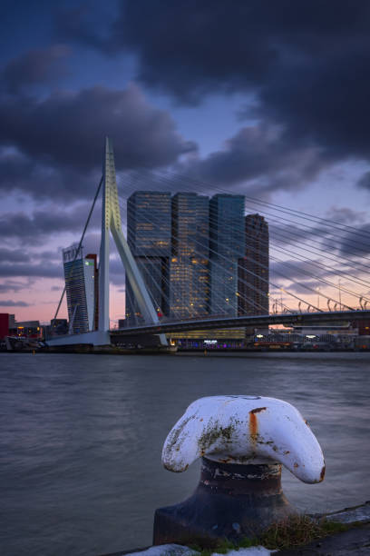 Rotterdam, Netherlands - January 19, 2024: bollard with Rotterdam's characteristic Erasmus bridge in the background