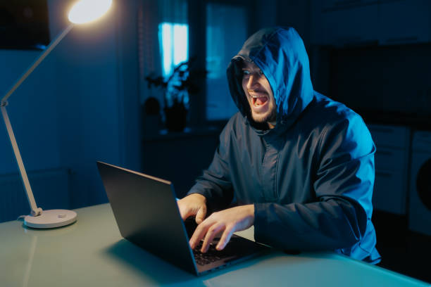 istock Enthusiastic Hacker Engaging in Cyber Fraud and Celebrating Success 2190180761