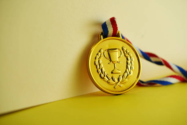 istock gold medal against yellow background 2190182047