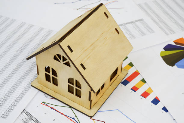 istock Wooden house on financial documents. 2190182252