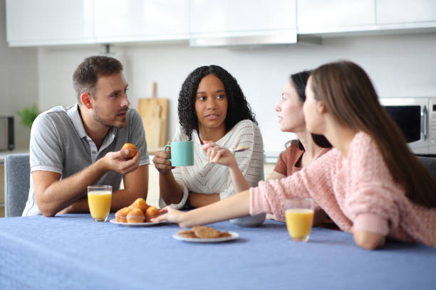 istock Serious friends at breakfast talking in the kitchen 2190182800