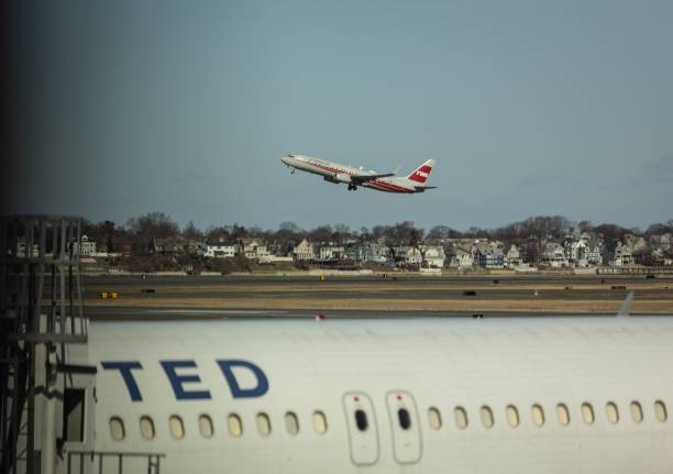 Boston, United States – January 04, 2024: United Airlines plane at Boston Logan Airport with American Airlines retro TWA livery in background