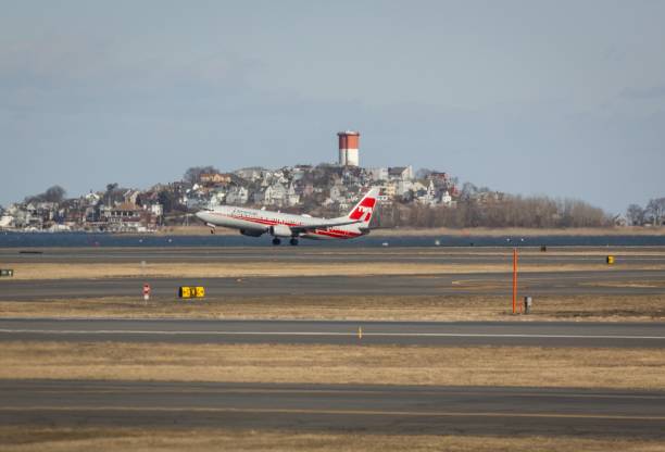Boston, United States – December 04, 2024: American Airlines plane with retro TWA livery takes off at Boston's Logan Airport on a sunny day