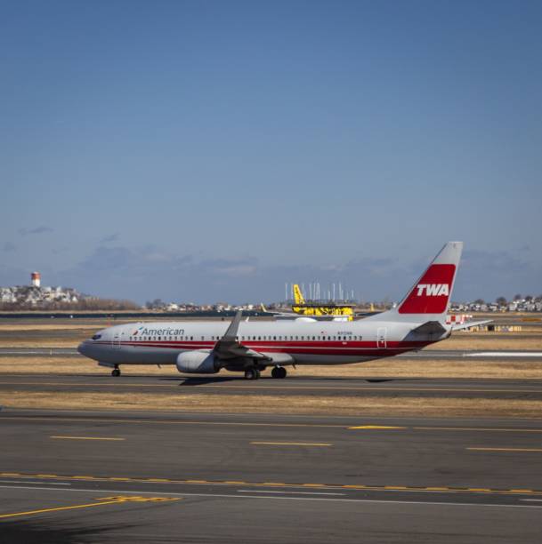 Boston, United States – January 04, 2024: American Airlines plane with retro TWA livery taxis at Boston Logan Airport on a sunny day