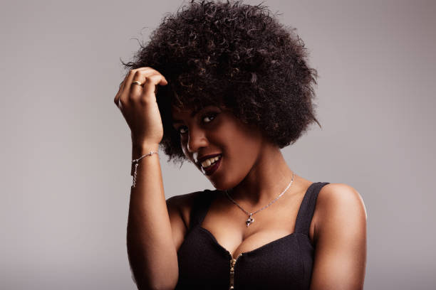 istock Latin american woman touching afro hair while smiling 2190186472