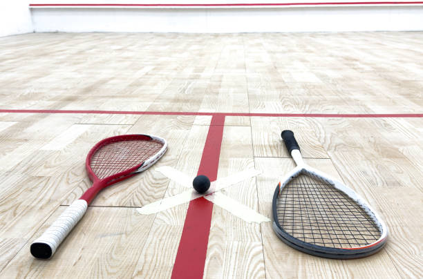 istock Two rackets and two squash balls lie on the parquet floor. 2190186710