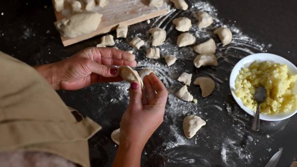 istock Hands shaping homemade filled dumplings 2190187520