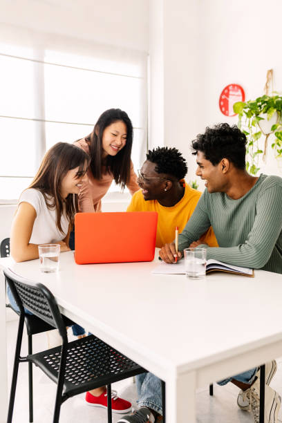 istock Smiling young diverse students doing homework together at home 2190188247