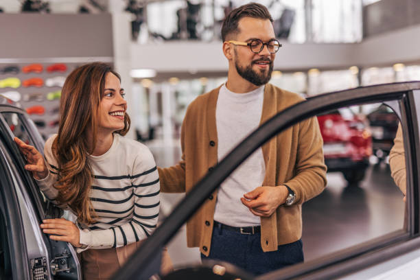 istock An attractive couple buying a new car 2190189344