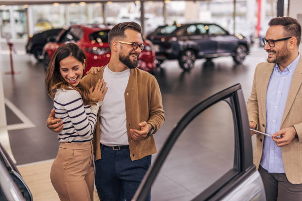 istock An attractive couple buying a new car 2190189905