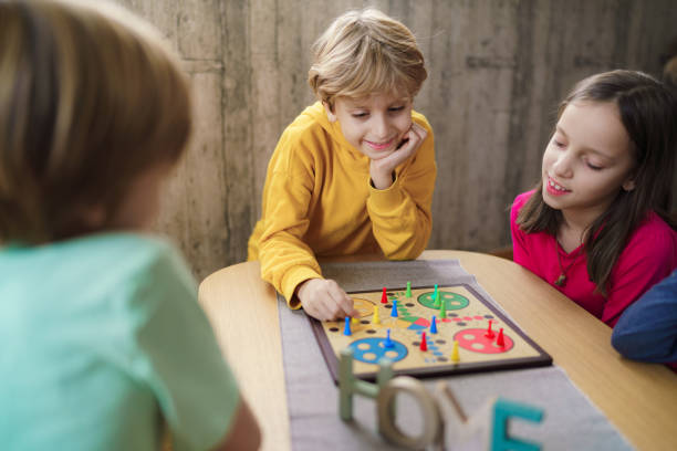 istock Group of children playing board game at home 2190190793