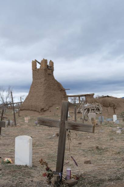 Historic old church in Taos with adobe architecture and blue sky