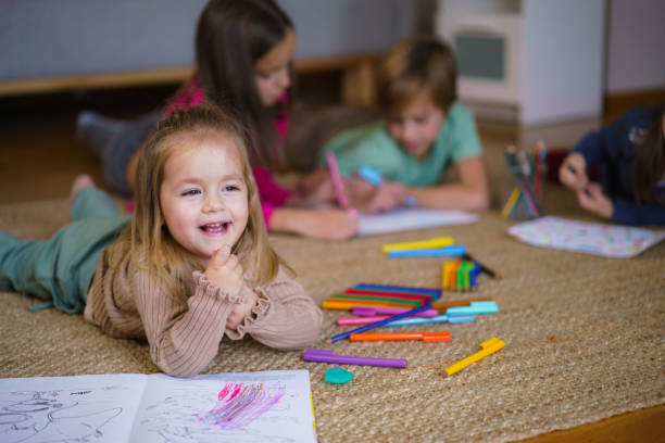 istock Group of children coloring with crayons at home 2190191376