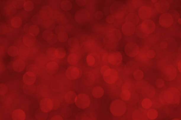 Red defocused sparkling background. Beautiful bokeh lights. Space for copy.