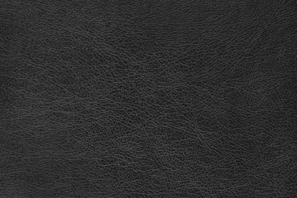 istock Structure of genuine leather, shiny black leatherette surface with slightly grainy texture 2190193432