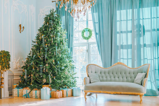 istock Beautifully decorated Christmas tree with gift boxes and vintage couch in elegant room 2190193470