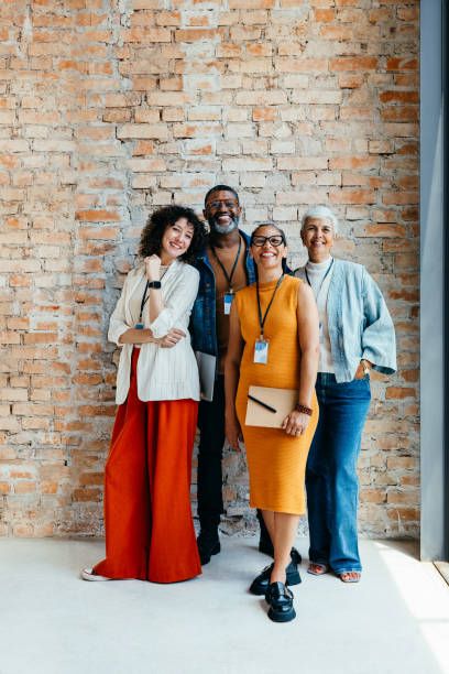 istock Confident multiracial coworkers standing together against a rustic brick wall 2190196065