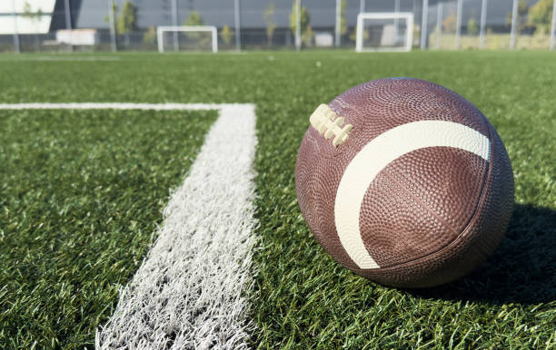 istock Rugby ball on green field 2190196075