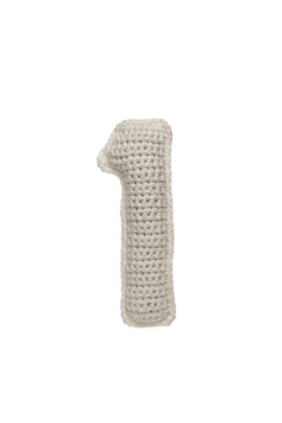 istock A crocheted number one in white yarn, isolated on a white background, perfect for educational materials, children's toys, or craft projects. 2190196097