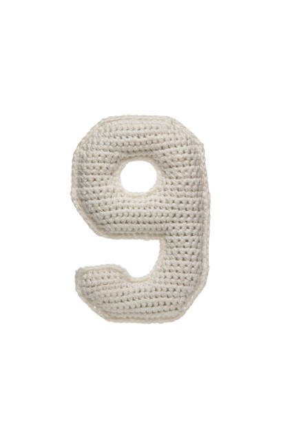 istock A crocheted number 9 in white yarn, isolated on a white background, perfect for educational materials, crafts, or decorative purposes. 2190196149