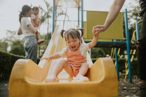 istock Asian young girl is laughing while playing in the playground. 2190196489