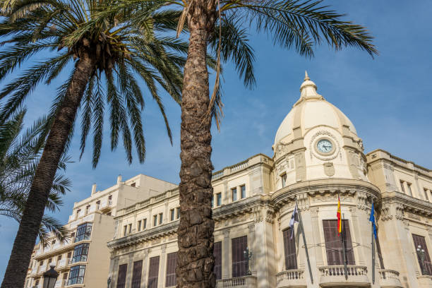 Ceuta, Spain - February 23, 2019: Palm trees and facades of historic buildings in the city of Ceuta, Spain