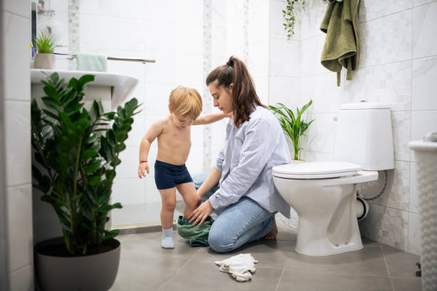 istock Mother undressing and preparing her boy for shower. 2190200223