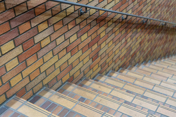 The stone floor and the shadow of people standing on the stairs on the floor