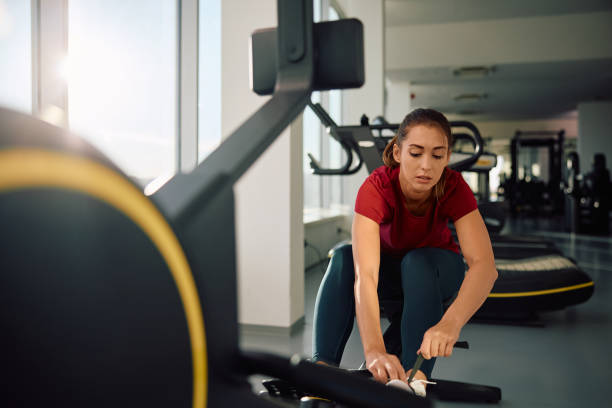 istock Athletic woman using rowing machine during sports training in a gym. 2190201661