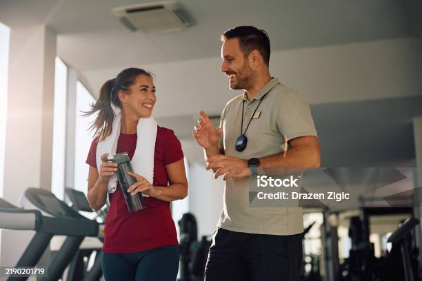Happy While Exercise Happy Athletic Woman Talking To Her Personal Trainer While Exercising ...