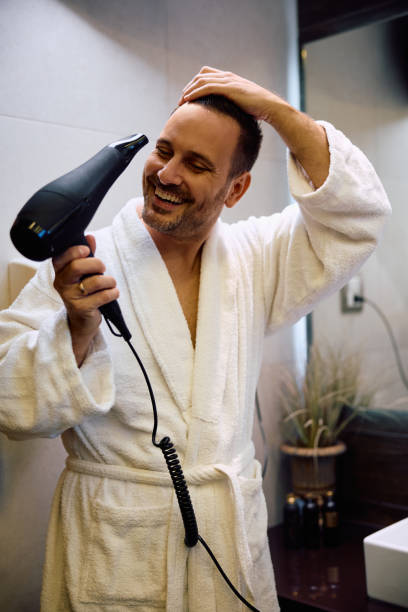 istock Happy man drying his hair after taking a bath. 2190201936