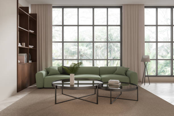 istock Light living room interior with green sofa, shelf and panoramic window 2190202581