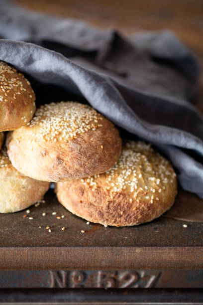 istock Bread with sesame seeds under grey napkin on rustic background 2190202637